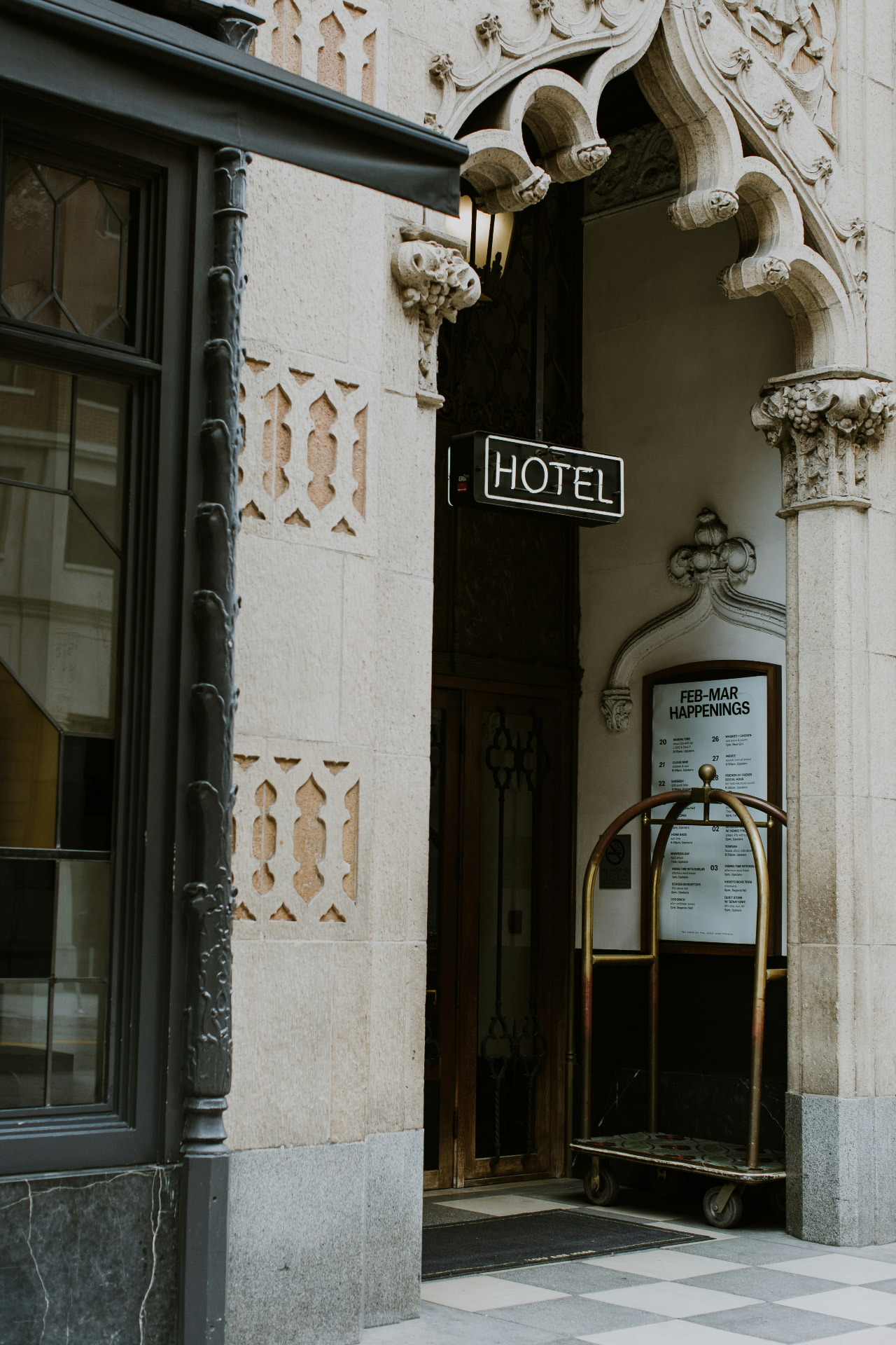 Historic hotel entrance with glowing HOTEL sign